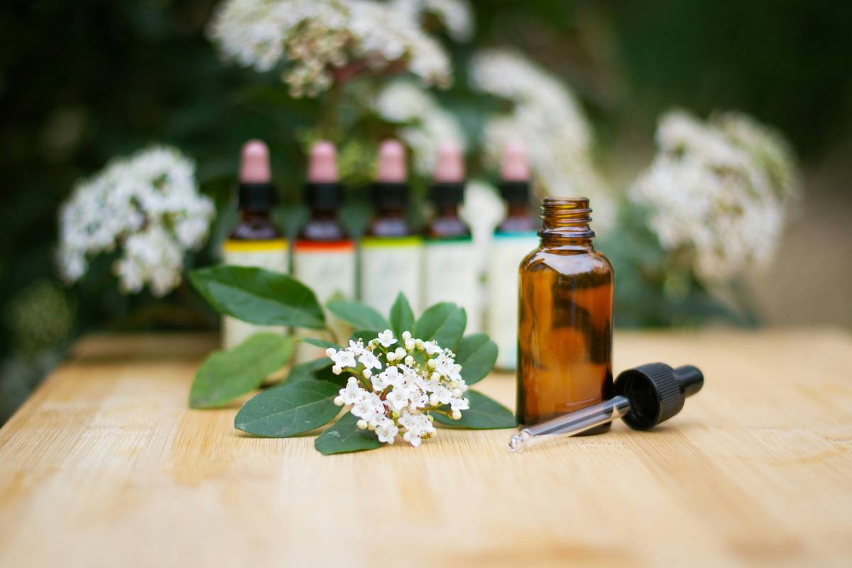 Woman applying diluted aromatherapy scented flower fragrant essential oil to wrists