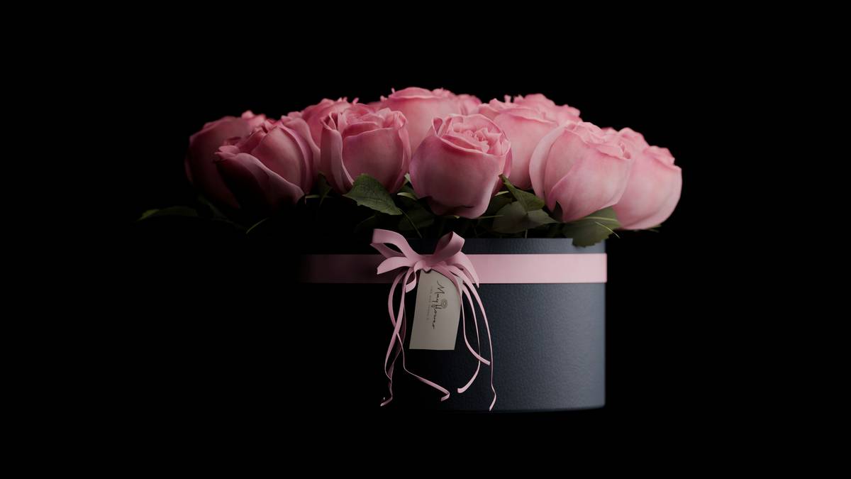 Assorted luxury rose scented gifts for women including body oil, hand cream, and bath salts arranged on linen